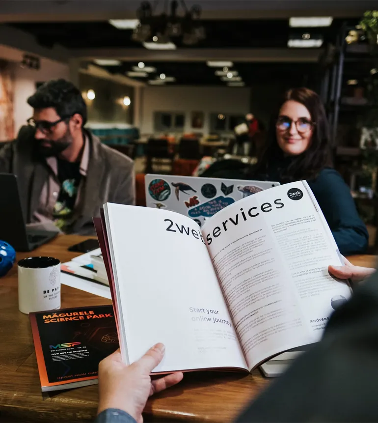 Close view of open pages from a thoughtfully designed booklet containing member-written stories and reflections.